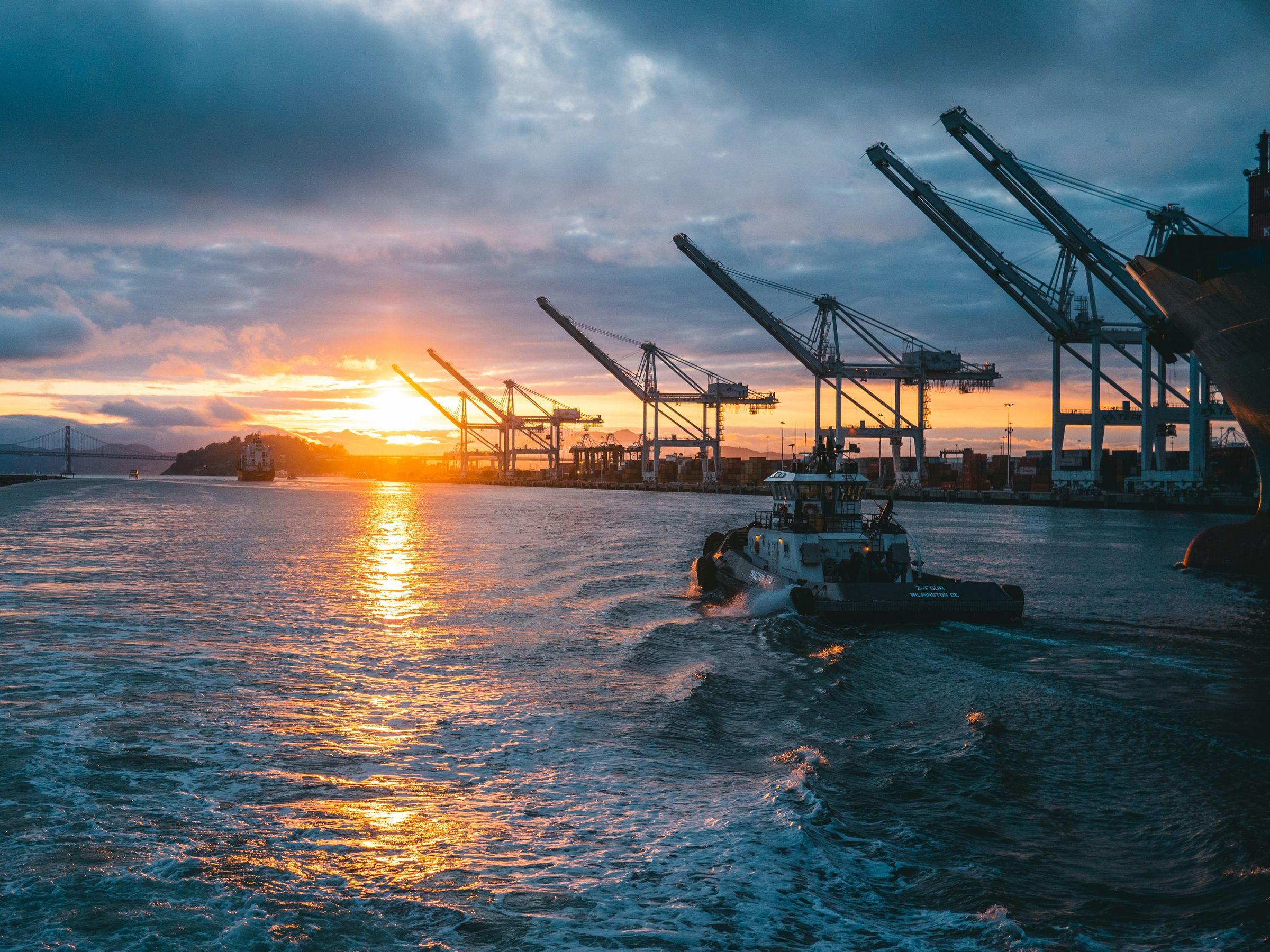 Container cranes at a port at sunset